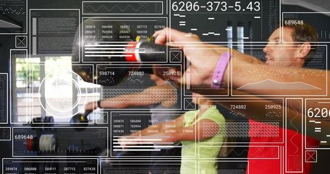 Man swinging kettlebell in group fitness class with augmented hud overlay and mirror studio