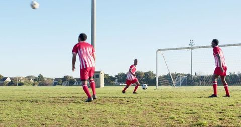 Youth soccer team practicing on open field
