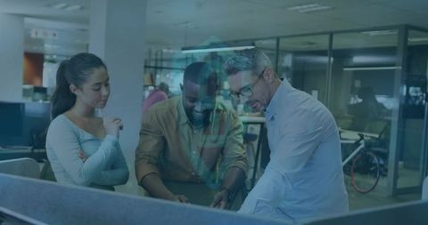 Team Collaborating Over Computer Screen in Modern Office Environment