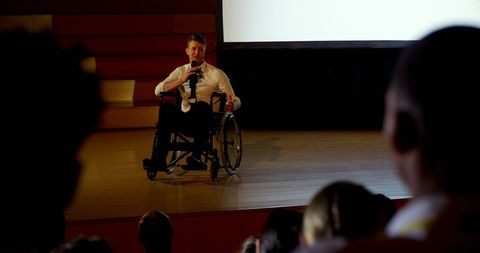 Disabled Businessman Speaking at Seminar from Wheelchair