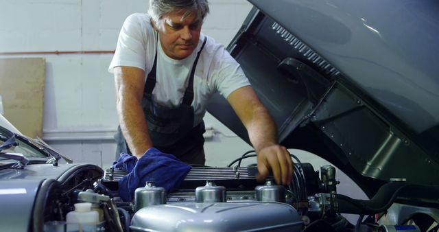 Experienced Mechanic Working on Car Engine in Garage - Download Free Stock Images Pikwizard.com