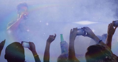 Energetic Singer Performing on Foggy Concert Stage with Vibrant Atmosphere