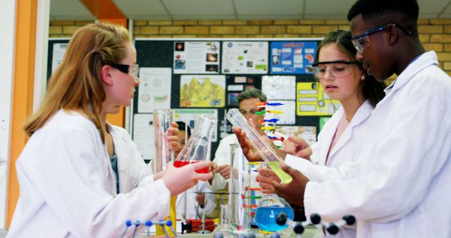 Caucasian and African American teenagers are engaged in a science experiment in a laboratory setting, with copy space. Dressed in lab coats, they collaborate and learn, showcasing the practical side of education.