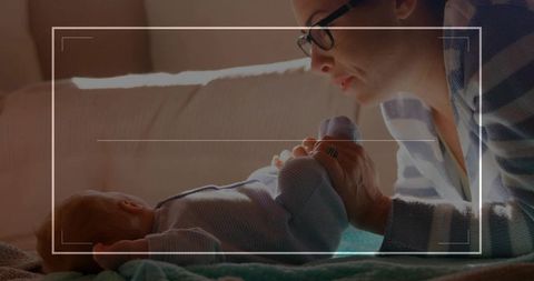 Mother Bonding with Infant on Cozy Living Room Sofa