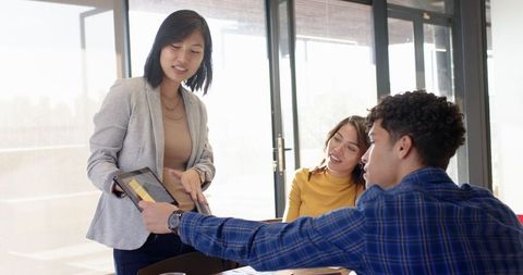 Diverse Team Collaborating with Tablet at Modern Office