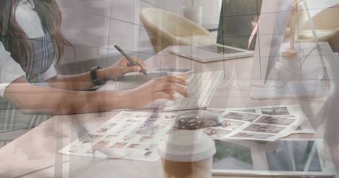 Creative Professional Typing at Desk With Multiple Exposure to Business Scene