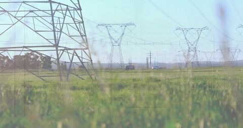 Lattice Transmission Tower Over Rural Landscape with Power Lines