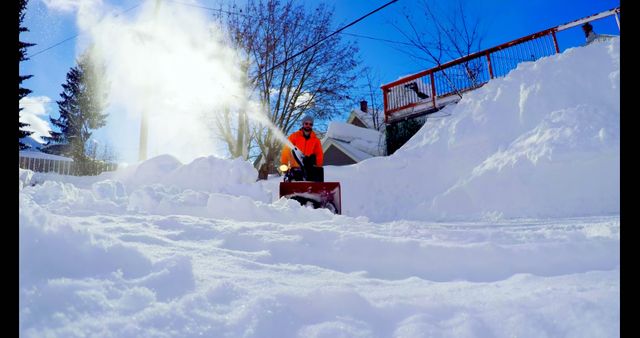 Man Clearing Snow Covered Yard with Snow Blower on Bright Winter Day - Download Free Stock Images Pikwizard.com