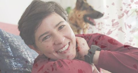 Smiling Woman Relaxing Indoors with Dog and Heart Graphics