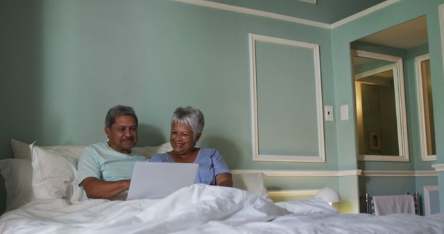 Happy Senior Couple Using Laptop in Cozy Bedroom - Download Free Stock Images Pikwizard.com