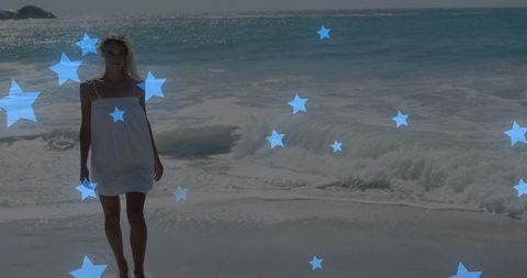 Walking barefoot on sunlit beach wearing white sundress, turquoise ocean and blue star overlays