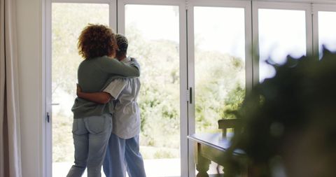 Loving Lesbian Couple Embracing by Sunlit Window at Home - Download Free Stock Images Pikwizard.com