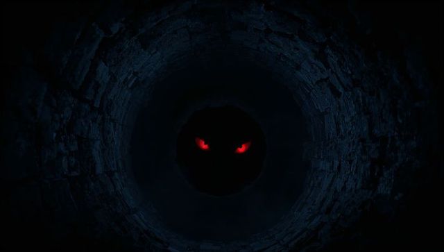Red demon eyes emerging from black void inside ancient brick well for horror fantasy art