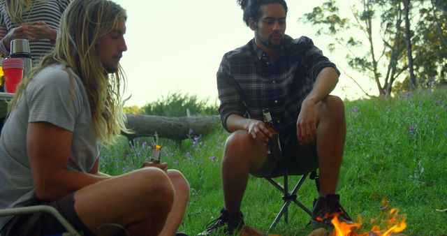 Friends Enjoying Campfire in Nature with Beverages - Download Free Stock Images Pikwizard.com