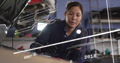 Female Mechanic Checking Engine with Flashlight, AR Diagnostics and Timeline Overlays