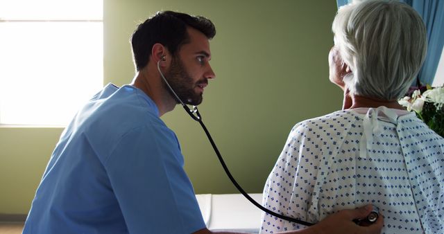 Doctor Examining Elderly Patient with Stethoscope in Hospital Room - Download Free Stock Images Pikwizard.com