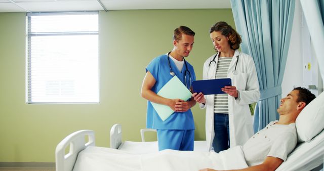 Doctors discussing patient's health in hospital room - Download Free Stock Images Pikwizard.com