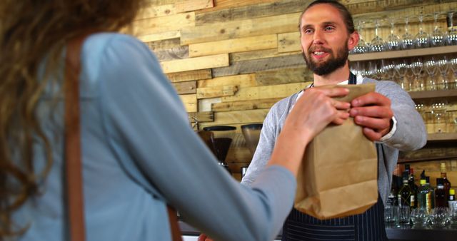 Barista Handing Takeaway Coffee Bag to Customer in Cozy Cafe - Download Free Stock Images Pikwizard.com