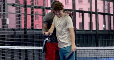 Friends Celebrating Win on Indoor Padel Court