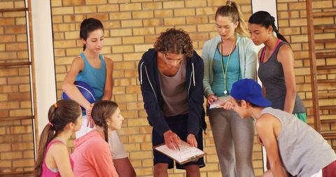High School Team Discussing Strategy on Indoor Court - Download Free Stock Images Pikwizard.com