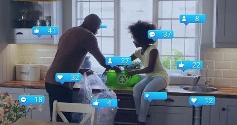 Black father and daughter sorting recycling in sunlit kitchen with green bin and social icons