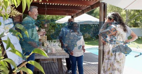Laughing friends enjoying poolside gathering under wooden pergola, casual backyard party