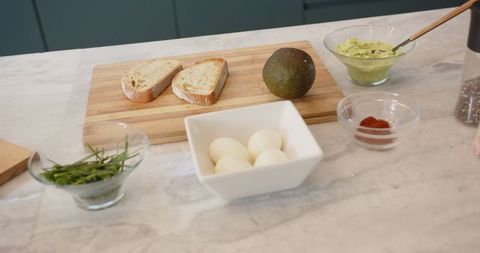 Fresh Avocado Toast Preparation on Marble Counter