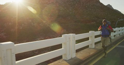 Man with Prosthetic Leg Trekking Across Mountain Bridge - Download Free Stock Images Pikwizard.com