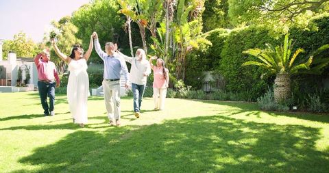 Joyful Senior Couple Celebrating Outdoor Wedding with Friends