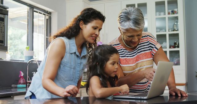 Three Generations of Women Using Laptop in Kitchen - Download Free Stock Images Pikwizard.com