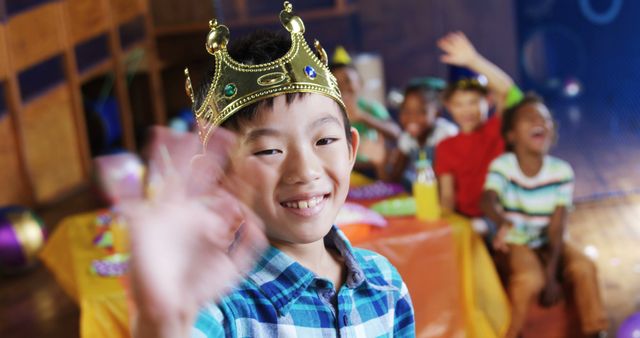 Smiling Boy Wearing Crown Waving at Birthday Party - Download Free Stock Images Pikwizard.com