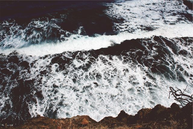 Aerial View of Ocean Waves Crashing Against Rocky Shoreline - Download Free Stock Photos Pikwizard.com