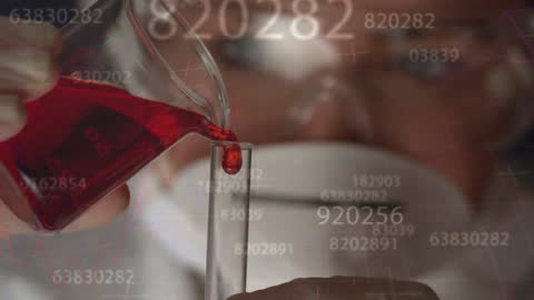 Scientist Analyzing Data and Red Liquid in Laboratory Setting