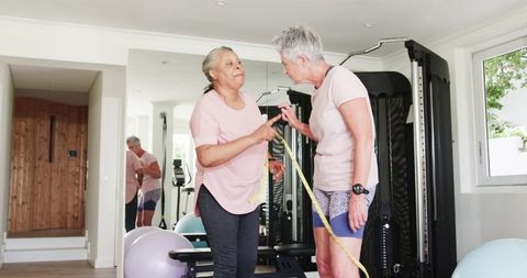 Senior couple embracing and encouraging fitness journey at home gym