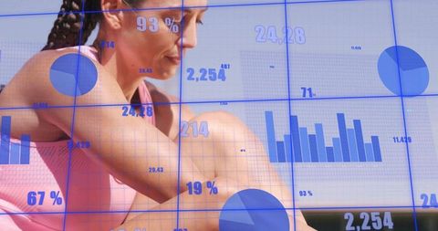 Midadult woman wearing pink tank sitting hugging knee with fitness analytics overlays