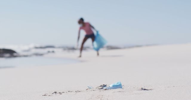 Volunteer Cleaning Beach Focuses on Discarded Face Mask Litter - Download Free Stock Images Pikwizard.com