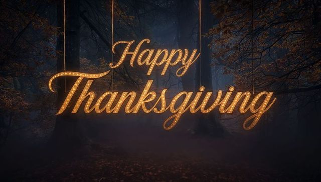 Glowing happy thanksgiving marquee hanging in foggy autumn forest with vintage bulb lights