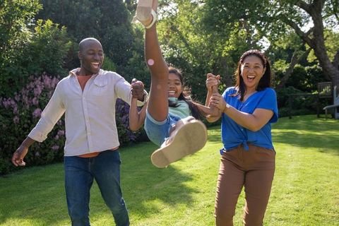 Diverse Family Enjoying Fun Time in Sunny Backyard Garden