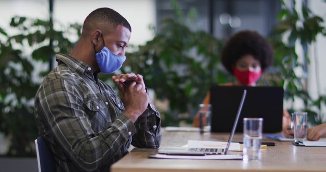 Focused Professionals Working with Masks in Modern Office - Download Free Stock Images Pikwizard.com