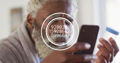 Mid adult man scanning sample jar with smartphone and augmented reality hud in bathrobe