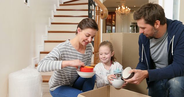 Family Packing Kitchen Items for Relocation in Spacious Home - Download Free Stock Images Pikwizard.com