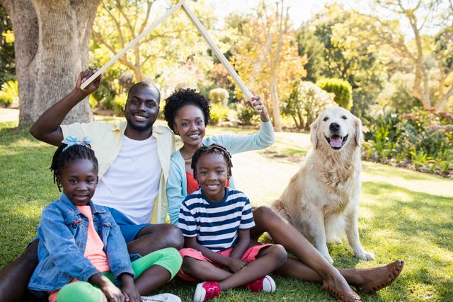Happy African American Family with Dog Relaxing in Park - Download Free Stock Photos Pikwizard.com