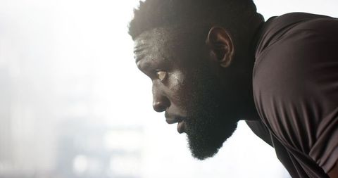 Focused athlete catching breath after intense workout