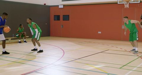 Coach whistling, african american guard dribbling and passing with defenders shifting