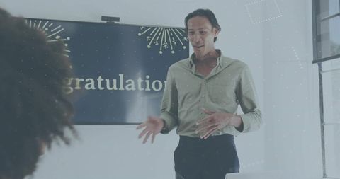 Business presenter leading office celebration with congratulations display and laptop