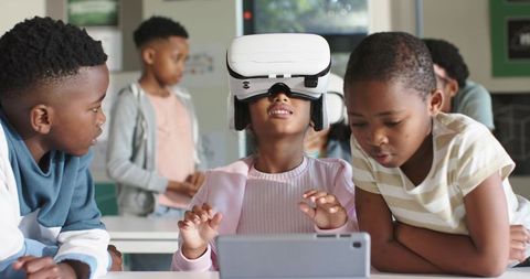African American kids exploring virtual reality on tablet during classroom collaboration