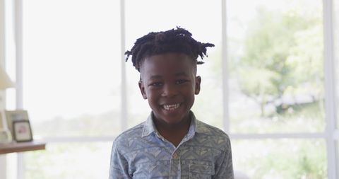 Cheerful Boy Smiling Indoors by Sunlit Window - Download Free Stock Images Pikwizard.com