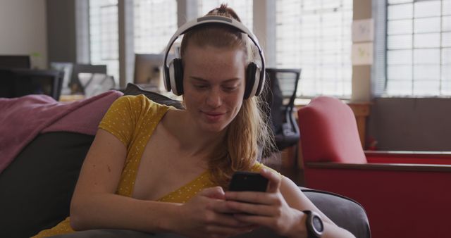 Young Woman Relaxing with Headphones and Smartphone Indoors - Download Free Stock Images Pikwizard.com