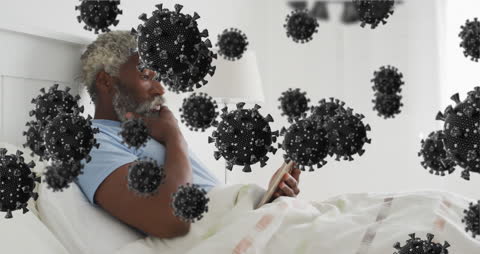Senior Man in Bed with Overlay of Virus Symbols