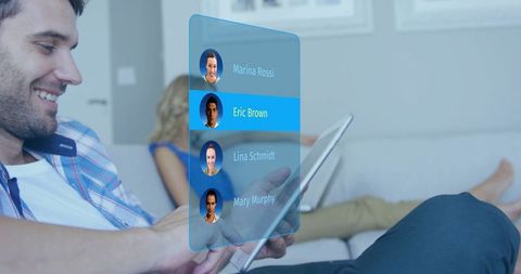 Holding Tablet with Holographic Contact List in Cozy Living Room for AR Communication